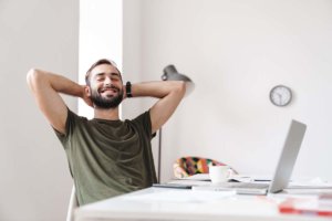 man smiling and leaning back safely celebrating recovery milestones and important milestones in recovery