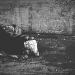 close up black and white photo of homeless person's shoes